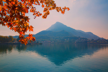 Autumn lake panorama, Como lago in Italy, beautiful red leaves. Fall in Lombardia. 