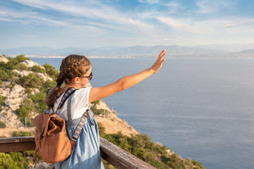Fototapeta premium Young beautiful girl traveling along the coast of the Mediterranean Sea.