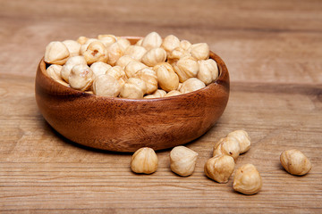 Hazelnut in a bowls on wooden table. Healthy food and snack.