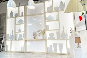 modern white studio. with a light stand in the middle, with a special light on the back wall.