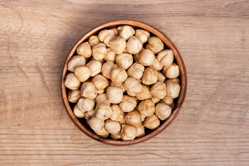 Hazelnut in a bowls on wooden table. Healthy food and snack.