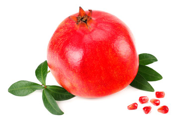 piece of pomegranate with seeds and green leaves isolated on a white background.