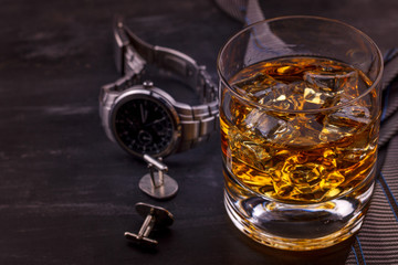 Male concept for father's day. Tie, watches, cufflinks and a glass of whiskey with ice