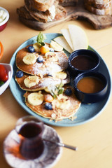 Delicious breakfast with pancakes and tea on a table