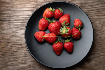 Strawberry on a black plate
