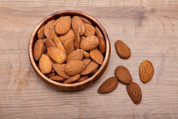 Almond in a bowls on wooden table. Healthy food and snack.