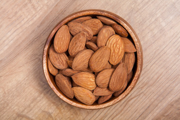 Almond in a bowls on wooden table. Healthy food and snack.