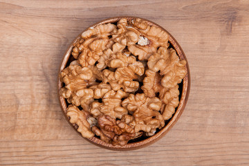 Walnut in a bowls on wooden table. Healthy food and snack.
