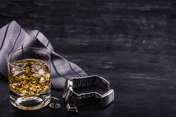 Male concept for father's day. Tie, watches, cufflinks and a glass of whiskey with ice