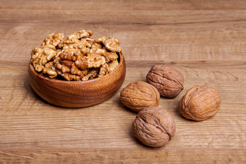 Walnut in a bowls on wooden table. Healthy food and snack.