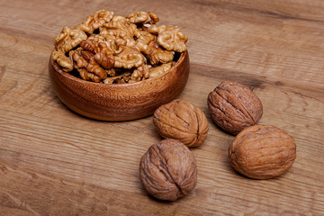 Walnut in a bowls on wooden table. Healthy food and snack.