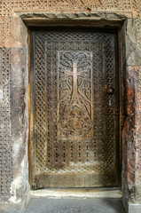 Entrance wooden door with a carved cross to the Church of the Holy Virgin in the fortress of Khor Virap