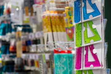 Student rulers in the store against the background of other stationery products