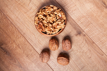 Walnut in a bowls on wooden table. Healthy food and snack.
