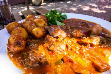 Lamb meat in vegetable sauce and potato.