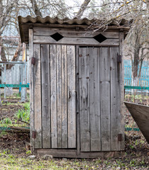 Old wooden toilet on the plot