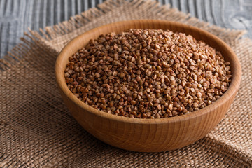 Grain buckwheat on a gray wooden background