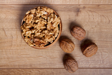 Walnut in a bowls on wooden table. Healthy food and snack.
