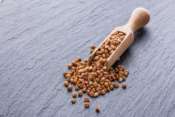 Grain buckwheat on a dark stone background