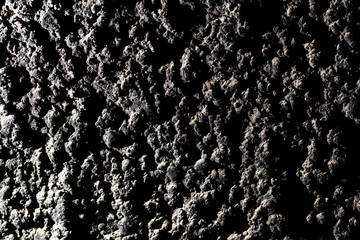 Black wall of sand and concrete as an abstract background