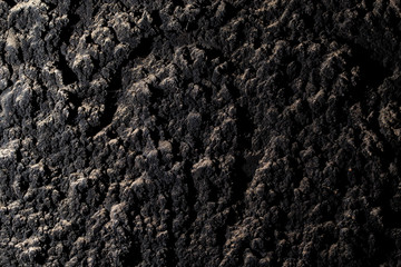 Black wall of sand and concrete as an abstract background