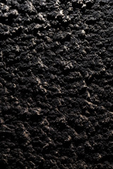 Black wall of sand and concrete as an abstract background