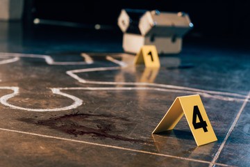 chalk outline, blood stain, investigation kit and evidence markers at crime scene - obrazy, fototapety, plakaty