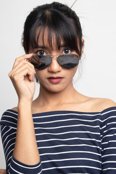 Portrait of beautiful young Asian woman with sunglasses