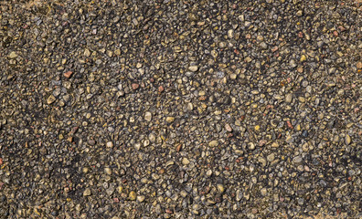 The texture of the road surface is made of small gravel.