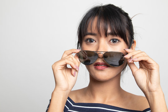 Portrait of beautiful young Asian woman with sunglasses