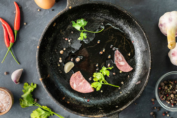 bacon or sliced meat and herb leafs on a hot oiled frying pan, scrambled eggs cookings