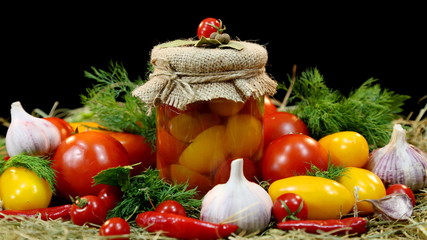 Bank with home preservation. Tomatoes, garlic, green dill, spices