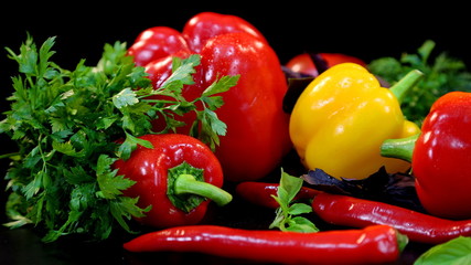 A green bunch of parsley and sweet and hot peppers. Vegetables