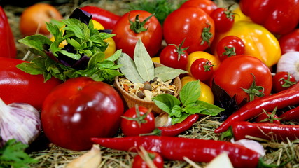 Red tomatoes, peppers, spices, herbs. Different fresh vegetables