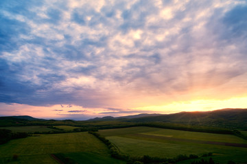 Obraz na płótnie Canvas Colorful sunset over a meadow