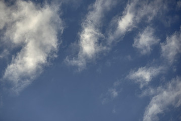 Obraz premium Background shot of blue sky with white clouds.