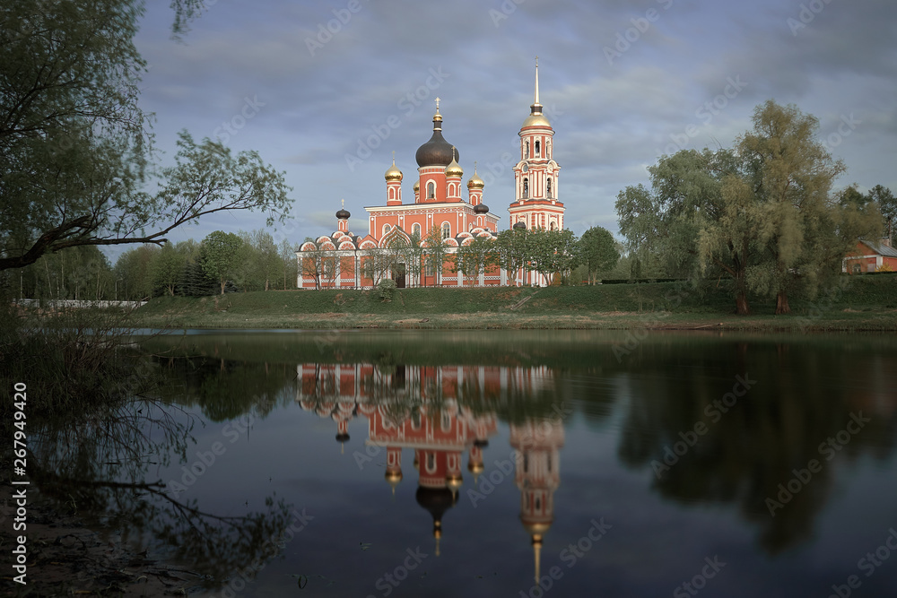 Wall mural Resurrection Cathedral in Staraya Russa is reflected in the river. Spring landscape.