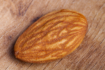 Almond on wooden table. Healthy food and snack.