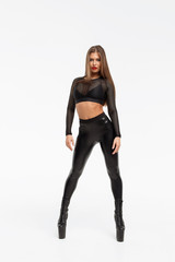 Erotic woman in leather pants and heels
