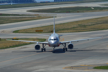Airplane taxiing on runway of the airport