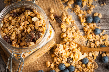 Healthy breakfast concept with oat flakes and fresh berries on rustic background. Food made of granola and muesli. Healthy banana smoothie with blackberries, honey and milk.
