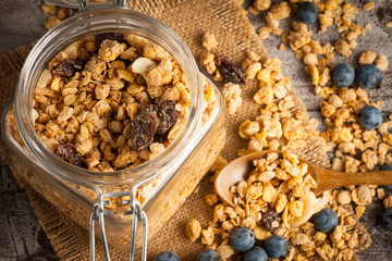 Healthy breakfast concept with oat flakes and fresh berries on rustic background. Food made of granola and muesli. Healthy banana smoothie with blackberries, honey and milk.