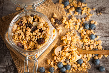 Healthy breakfast concept with oat flakes and fresh berries on rustic background. Food made of granola and muesli. Healthy banana smoothie with blackberries, honey and milk.