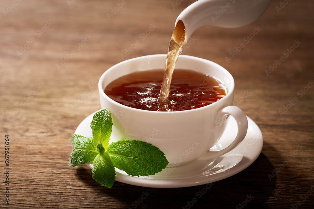 Wall mural pouring tea into a cup