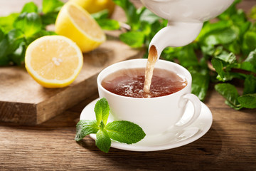 pouring tea into a cup