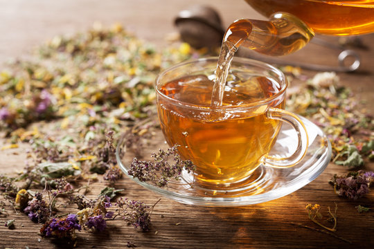 Pouring Herbal Tea Into A Cup