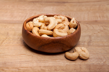 Cashew in a bowls on wooden table.Healthy food and snack.