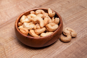 Cashew in a bowls on wooden table.Healthy food and snack.