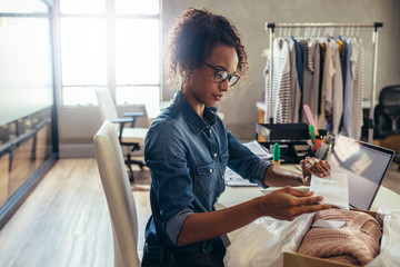 Small business owner packing in the card box at workplace