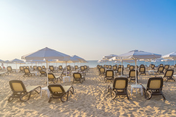 Chairs and umbrellas on a beautiful beach at sunrise in Sunny Beach on the Black Sea coast of Bulgaria